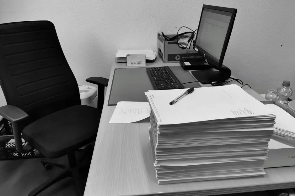 Office desk with paperwork and a computer, illustrating everyday small-business admin work